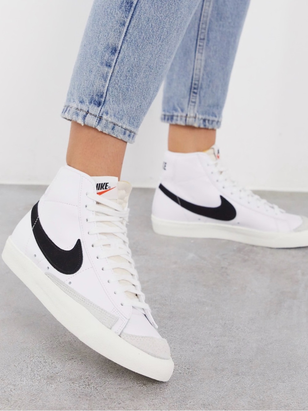 Nike White High-Top Sneakers with Black Swoosh